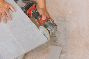 Canvas Print - Using an angle grinder polishing disk with diamond for polishing the corner edges of tiles cut with a cut angle grinder