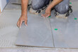 Installing ceramic tiles on an adhesive surface while working on the construction in reconstruction bathroom
