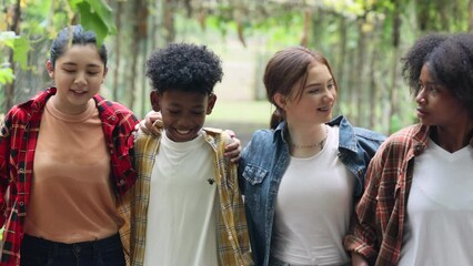 Wall Mural - Happy Multi-Cultural Children teenage. Group portrait diverse teenage boy and girls. Kids walking talking leaning outdoor summer camp