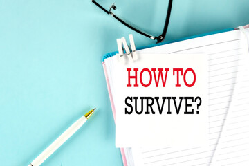 Poster - HOW TO SURVIVE text on a sticky on notebook with pen and glasses , blue background