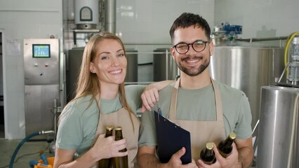 Wall Mural - Portrait of two brewer in craft brewery.