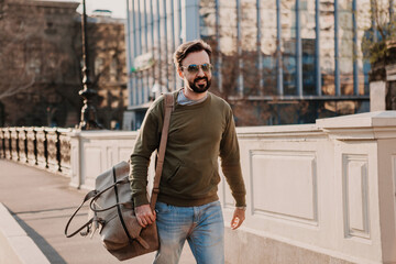 Wall Mural - hipster man walking in street with bag