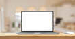 © Piman Khrutmuang - Laptop with blank screen on wood table with cafe coffee shop blur background