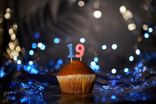 Holiday Or Birthday Digital Greeting Card Concept. Tasty Vanilla Cupcake Or Muffin With Number 19 Nineteen On Aluminium Foil And Blurred Bright Background. High Quality Photo