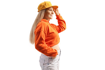 Poster - Casual young female in a sweathsirt and jeans holding her cap