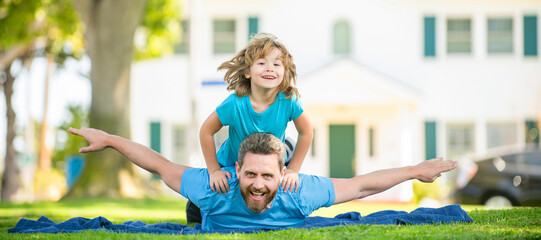 Wall Mural - Banner of father and son in summer park outdoor. fathers day. happy father and son having fun in yard. family value. childhood