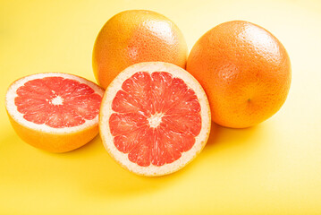 Wall Mural - Grapefruit, grapefruits positioned on yellow EVA surface, selective focus.