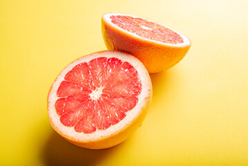 Wall Mural - Grapefruit, grapefruits positioned on yellow EVA surface, selective focus.