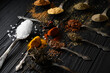 Colorful various herbs and spices for cooking on dark wooden rustic background