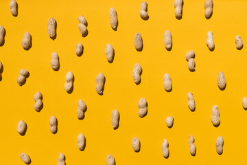 Wall Mural - Group of peanuts isolated on yellow background