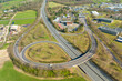 Leinwandbild Motiv Aerial view of highway road intersection with fast moving heavy traffic. Intercity transportation with many cars and trucks
