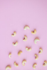 Wall Mural - Cashew nuts isolated on pink background