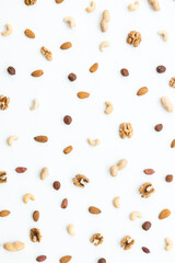 Wall Mural - Pattern of nuts mix. Cashew, peanut, hazelnuts, walnuts, almonds on white background