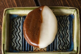Fototapeta  - 茶色と白色の二色のべこもち。北海道ではよく食べられる和菓子の一つ。