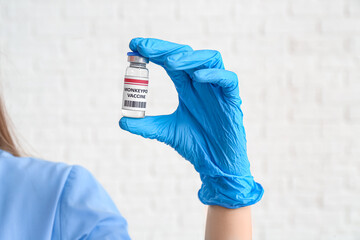 Wall Mural - Female doctor with monkeypox vaccine on white background, closeup