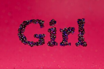Poster - beautiful multi-colored inscription girl consisting of patterns of small spheres, cubes, tori on a pink background. 3d render. 3d illustration