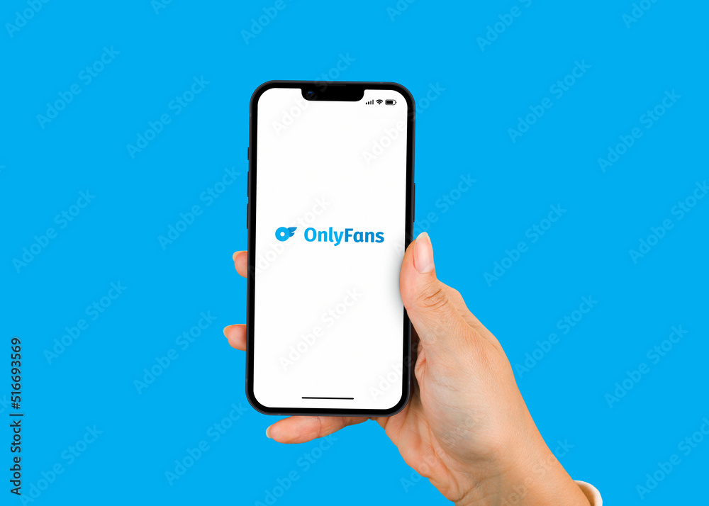 Female hand holding a smartphone iPhone with OnlyFans app app on the