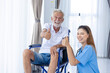 Portrait Nurse Medical Staff Support Service Senior Elderly Man Healthy on Wheel Chair thumbs up happy smile.