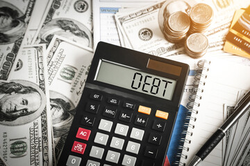 debt word in calculator in concept Debt management and financial accounting planning, refinance household debt and credit card debt.