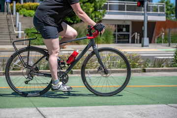 Wall Mural - Size plus woman wants to lose weight and rides a bike on a bike path in a modern city