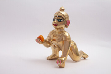 Wall Mural - Bal Krishna Laddu Gopal Brass Statue side Facing White Background