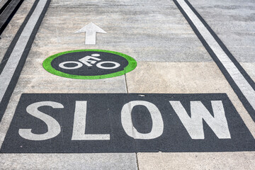 Wall Mural - Warning sign Slow for cyclists in a dedicated cycle lane in a heavily traffic area