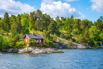 Small red cabin on scandinavian coastline