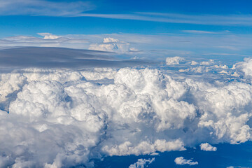 Canvas Print - Clouds from above. View from airplane.  blue sky view from plane. sky wallpaper with space for your text . Aerial view of the blue sky. High in the Heavens.   View from Airplane Window