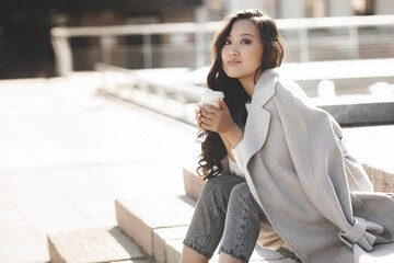 Wall Mural - Attractive young lady drinking coffee. Beautiful young woman closeup portrait. Female facial portrait.