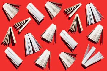Wall Mural - Creative pattern made of red books on vibrant red background. Education and knowledge concept. Flat lay.