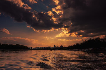 colorful dramatic sky with clouds, smoking cumulonimbus clouds reflect the golden light of the dawn sun.	
