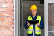 © Syda Productions - architecture, construction business and building concept - male architect in helmet and safety west with tablet pc computer in window