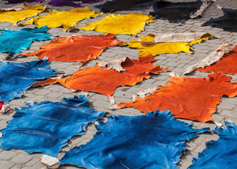 Traditional Arabic handmade colorful pieces of leather drying out in the sun in a local tannery before going on sale in the Souk in the downtown (old Medina) of Marrakesh, Morocco, Africa.