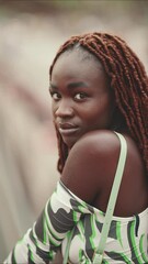 Wall Mural - VERTICAL VIDEO: Gorgeous woman with African braids wearing top standing on bridge in background motorway. Stylish girl turns her head and looks at the camera. Bokeh out of focus background