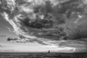 Wall Mural - Sunset Sailboat Storm Looming Ocean Clouds Black And White
