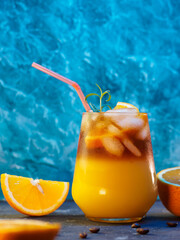 Wall Mural - cold bumble coffee. refreshing espresso coffee with orange juice and ice on a blue background. orang