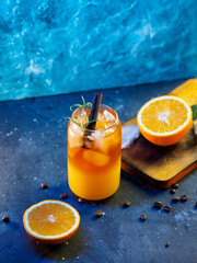 Wall Mural - cold bumble coffee. refreshing espresso coffee with orange juice and ice on a blue background. orang