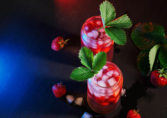 Wall Mural - two summer strawberry cocktails with ice . decorated with a strawberry leaf. top view, selective foc