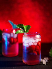 Wall Mural - strawberry cocktail with ice cubes. a refreshing summer drink. decorated with a sprig of strawberrie