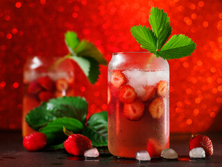 Wall Mural - strawberry cocktail with ice cubes. a refreshing summer drink. decorated with a sprig of strawberrie