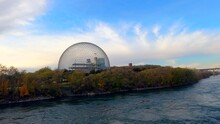 Biosphere of Montreal at Park Jean Drapeau Montreal Canada, Environment Museum, Hard Steel Truss Architectural Structure-Dome next to River, Beautiful Sunset Landscape view, blue cloudy sky