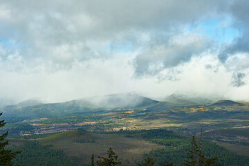 Wall Mural - Misty mountain view with clouds and fog in central Oregon in autumn season.