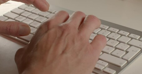 Poster - Man's hands fingers typing a message on the keyboard. He presses the buttons, sends an e-mail. Communication using computer technology. White table.