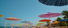 Low Angle View Of Colorful Beach Umbrellas And Sky Background