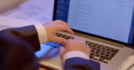 Leinwandbilder - Using a laptop on the table. The employee presses the application control buttons. Ring on the hand. Sleeves. The motion of the picture on the monitor.