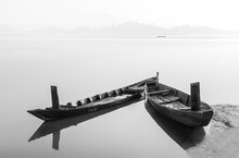 Wooden Boats Are Moored On The Lake In The Early Morning. Dak Lak Province, Vietnam.