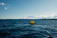 Single Yellow Buoy Alone On Blue Lake