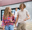 © JackF - Smiling teenagers boy and girl walking home after finishing college lessons on summer day