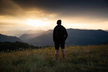 Wall Mural - man in nature looking at sunset