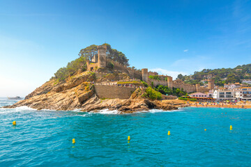 Wall Mural - view of the 12th century castle, the sandy beach, whitewashed town and turquoise waters of the Costa Brava coast along the Mediterranean Sea, at Tossa de Mar, Spain.	